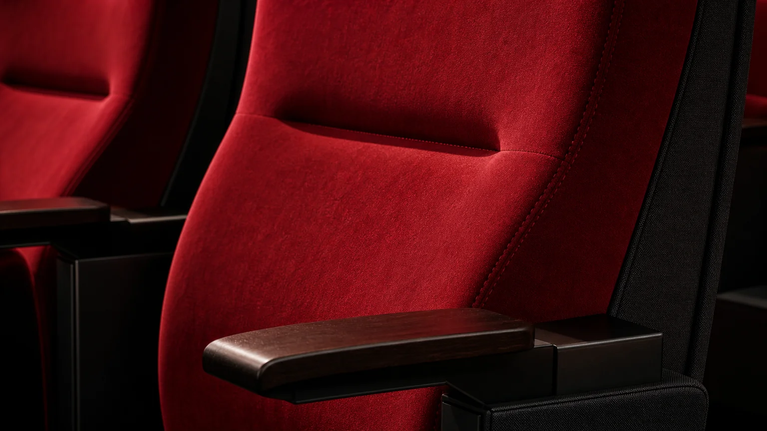 Gros plan sur le velours, le dossier et l’accoudoir de fauteuils de cinéma